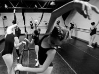 Ari Sweet, 16, leans over on the barre while performing a Cambre Side with her fellow E class students at the New Bedford Ballet studio on Purchast Street in the north end of New Bedford.   [ PETER PEREIRA/THE STANDARD-TIMES/SCMG ]